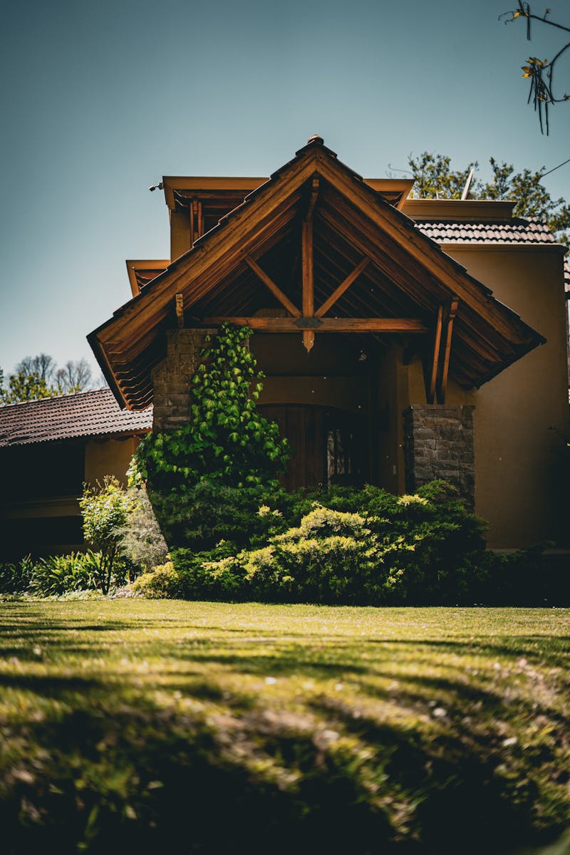 Beautiful entrance of a house covered with ivy and surrounded by a lawn in Luján de Cuyo, Argentina.